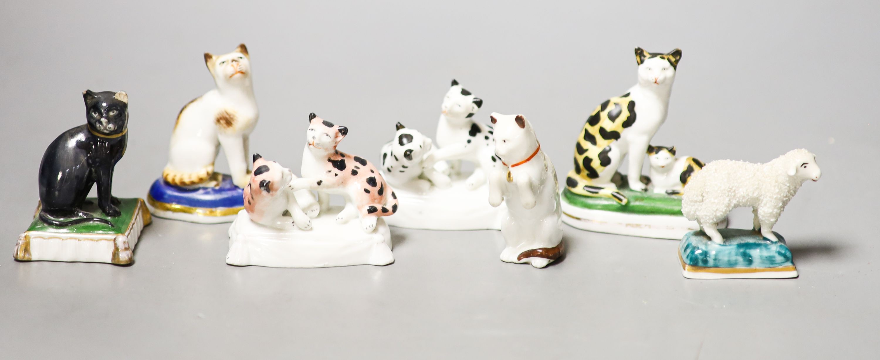 Six French porcelain cat figures or groups, and a similar sheep figure, late 19th century